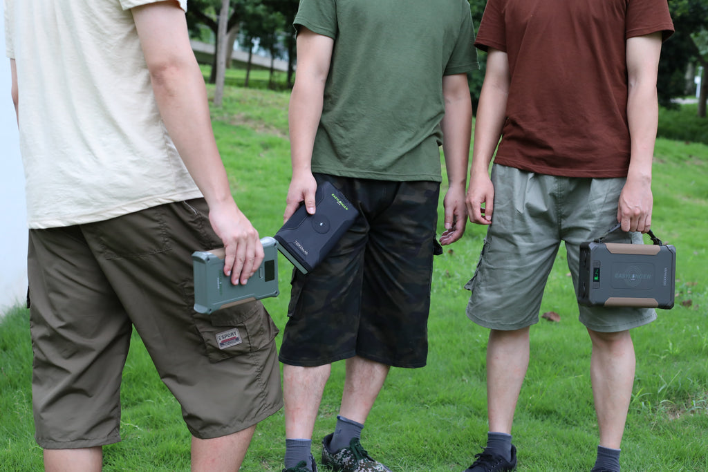 Three people outdoors carrying different EASYLONGER battery models