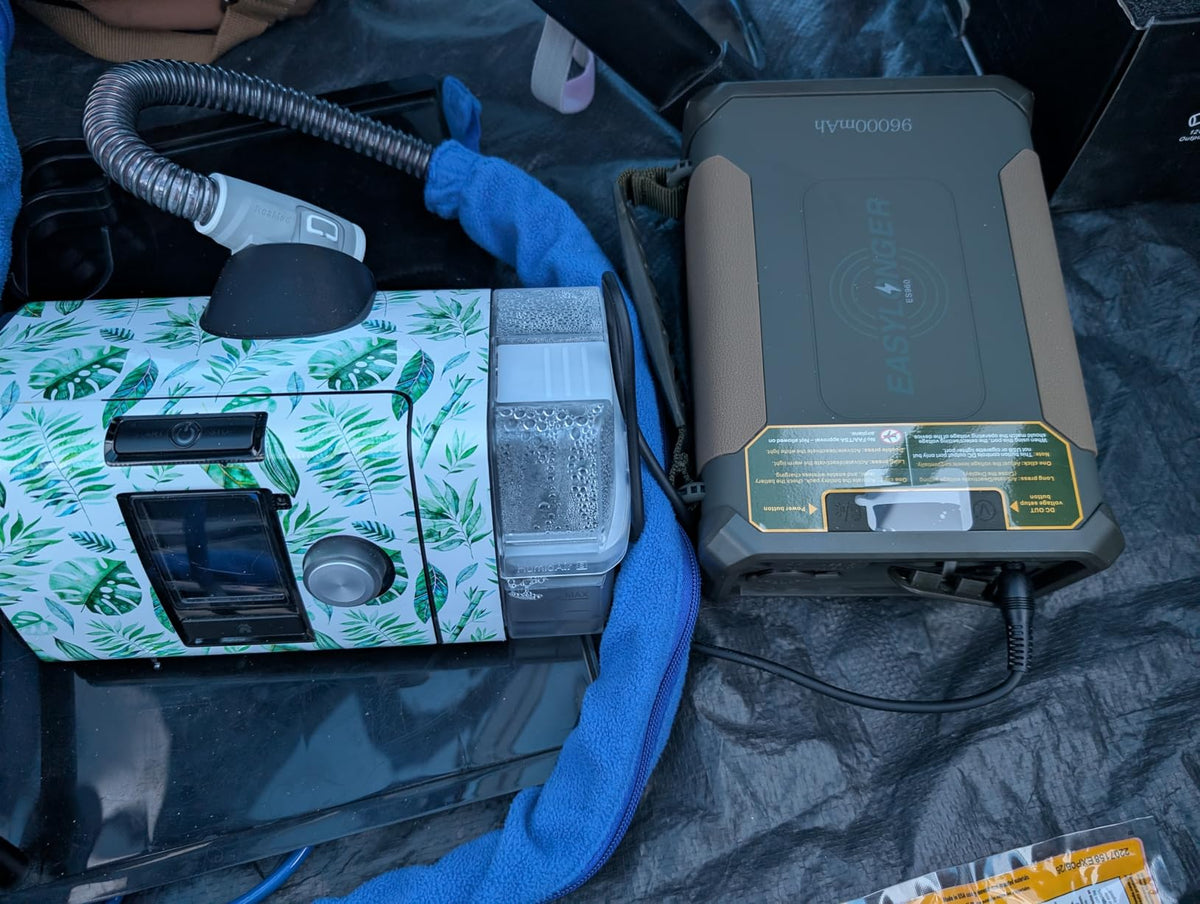 ES960 battery beside a ResMed CPAP, humidifier chamber and tubing