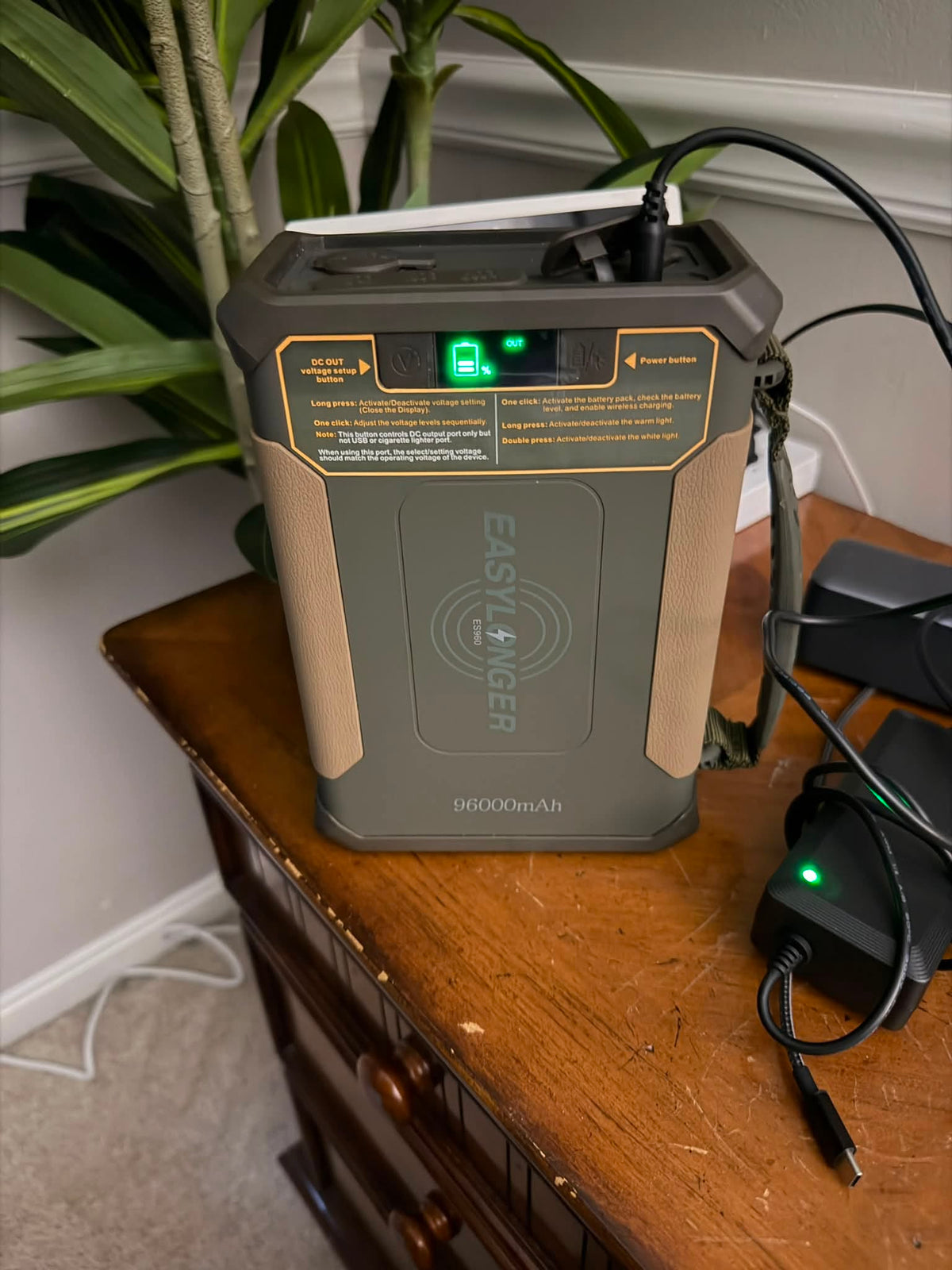 ES960 battery and charging equipment on a wooden side table
