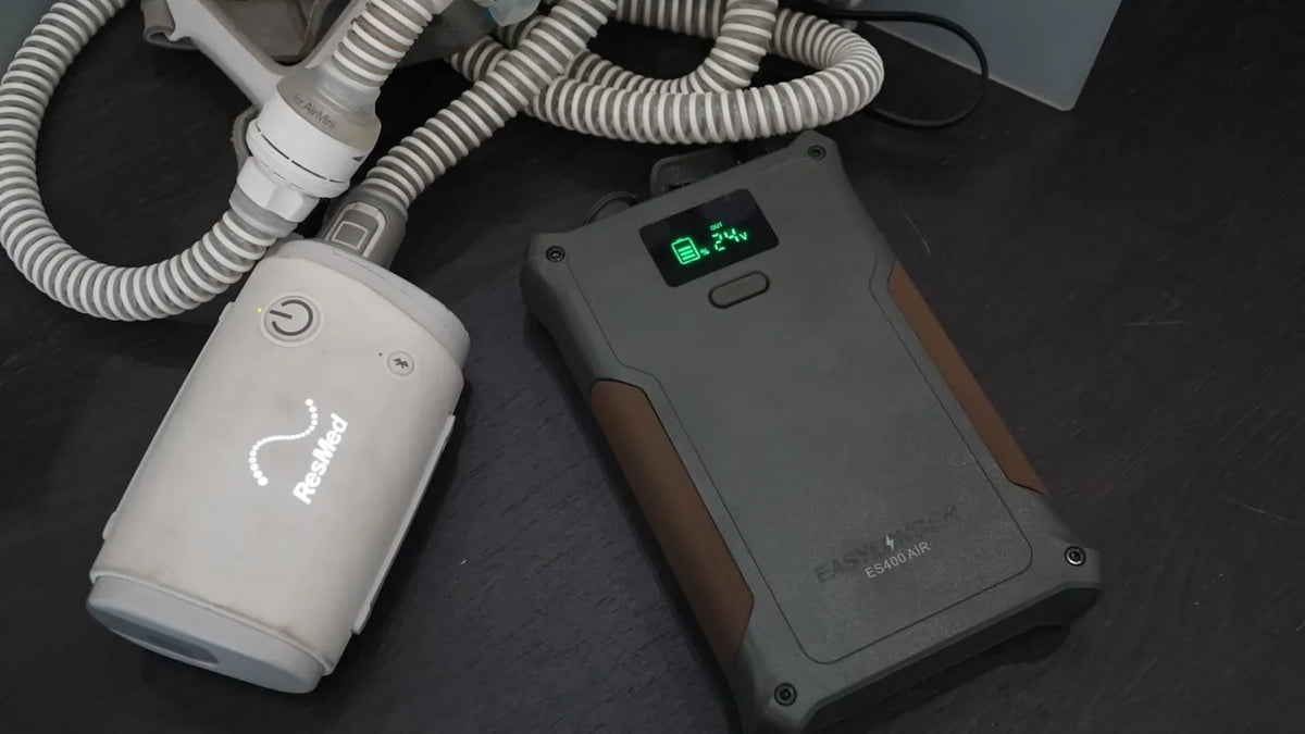 ResMed AirMini beside an EASYLONGER ES400 AIR on a dark tabletop