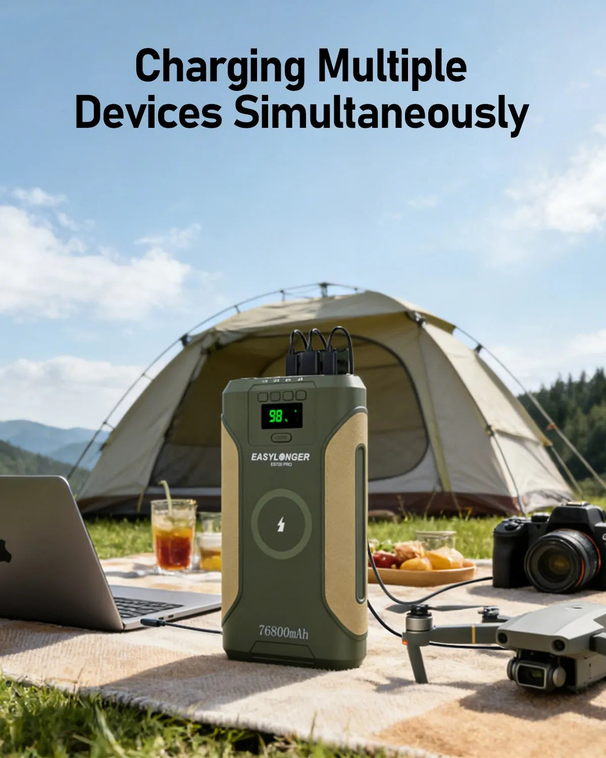 The EASYLONGER ES720 PRO CPAP Battery Backup sits on a picnic table outdoors, powering devices like a laptop, camera, and drone. With a tent and trees nearby, it’s the ideal camping power supply for all your needs.