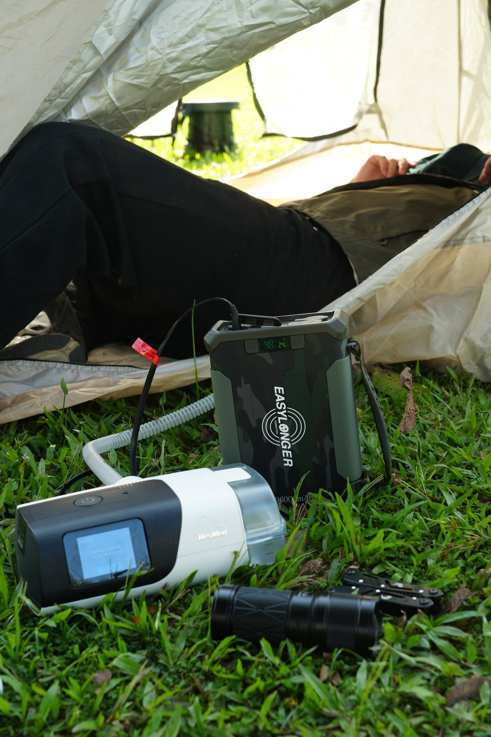 EASYLONGER CPAP battery powering a CPAP machine inside a tent