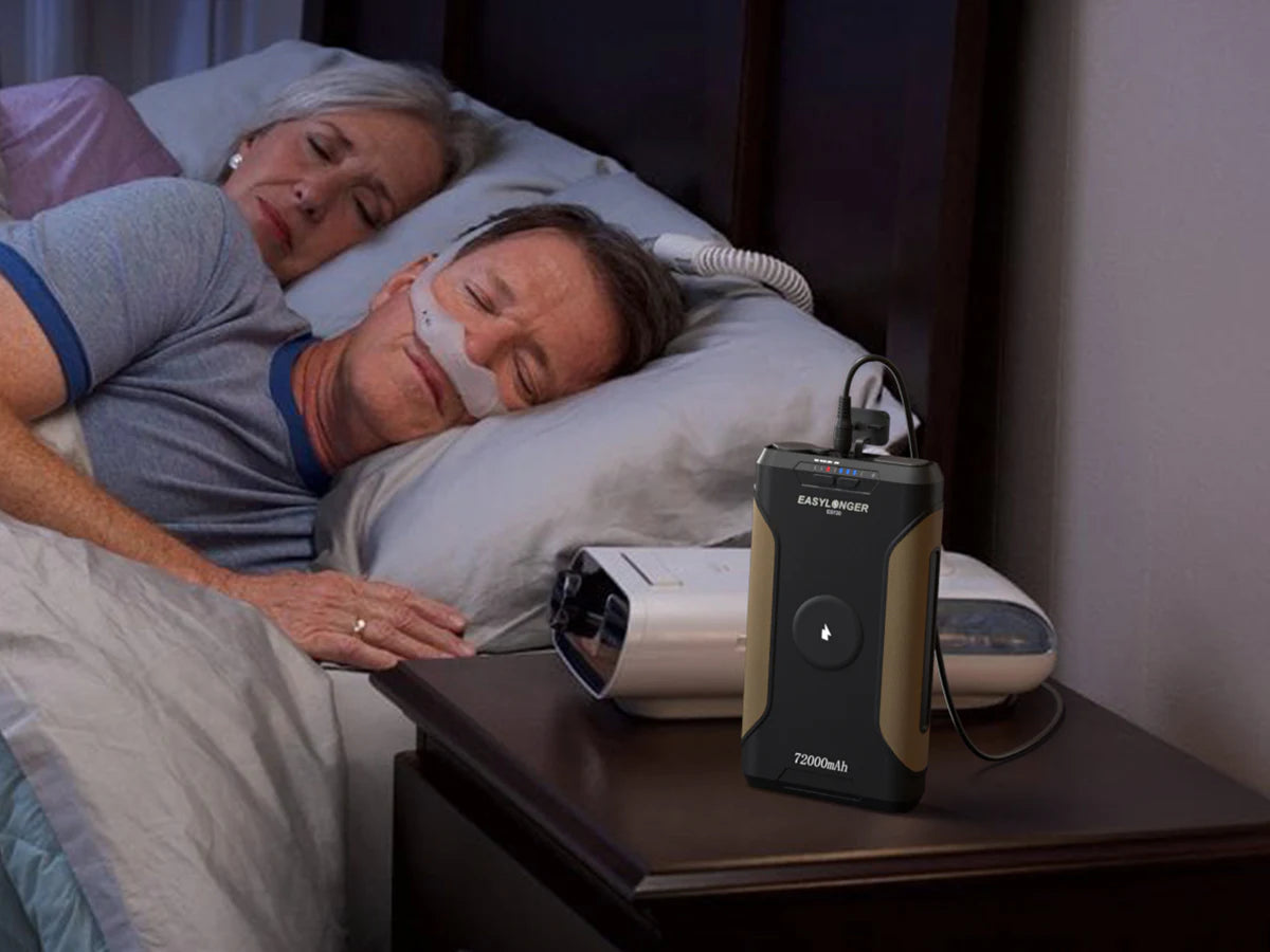 A CPAP user sleeping with an EASYLONGER battery and CPAP machine prepared beside the bed