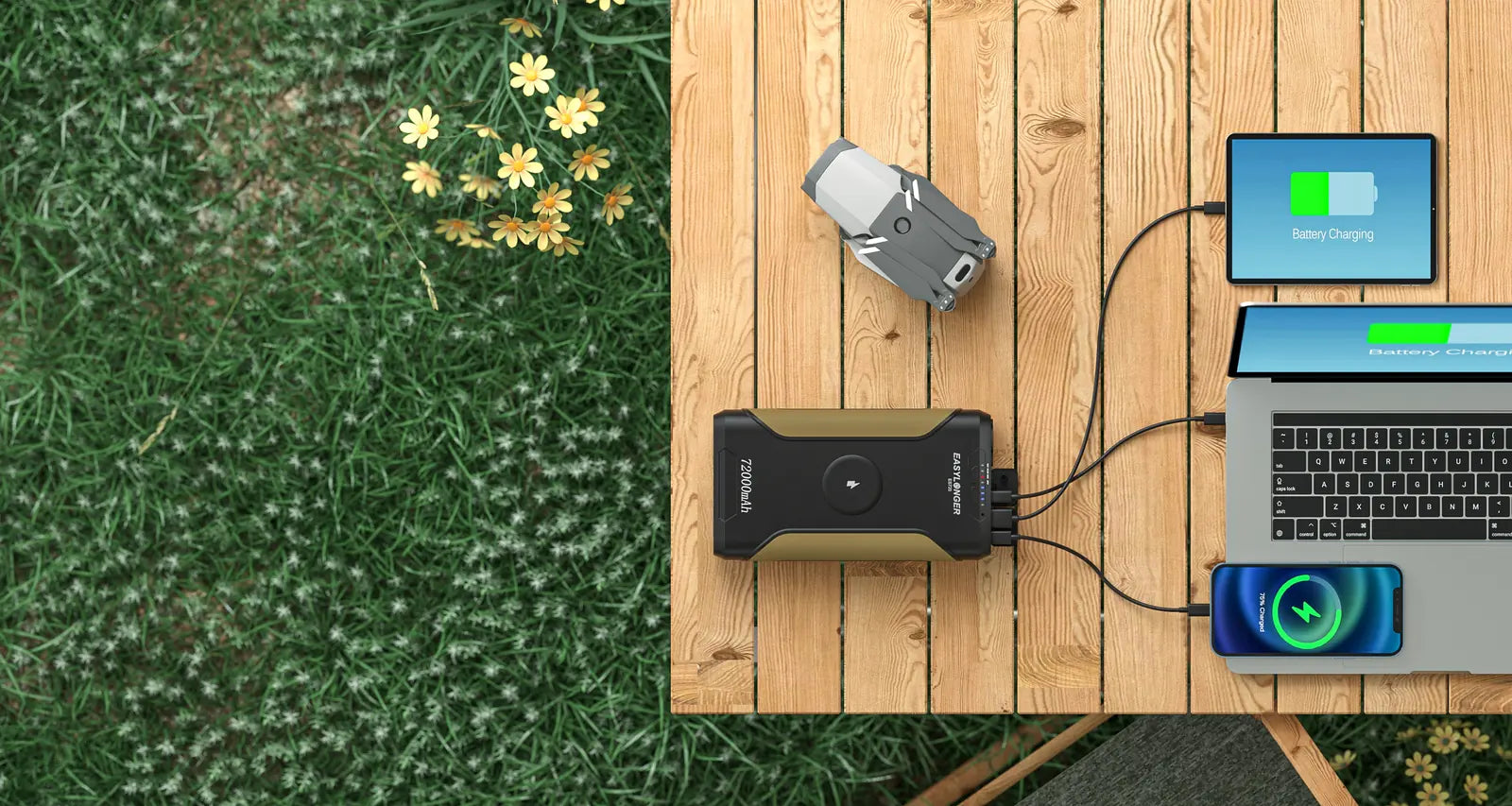 ES720 charging a laptop and a phone on a wooden deck