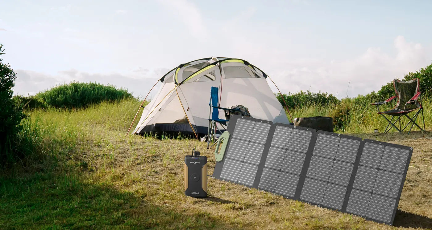 An ES720 and a solar panel on the grass beside a tent