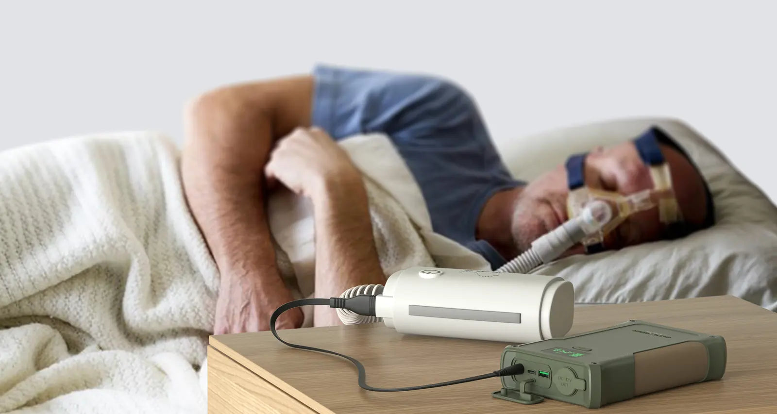 A man asleep on CPAP with an ES400 AIR on the nightstand