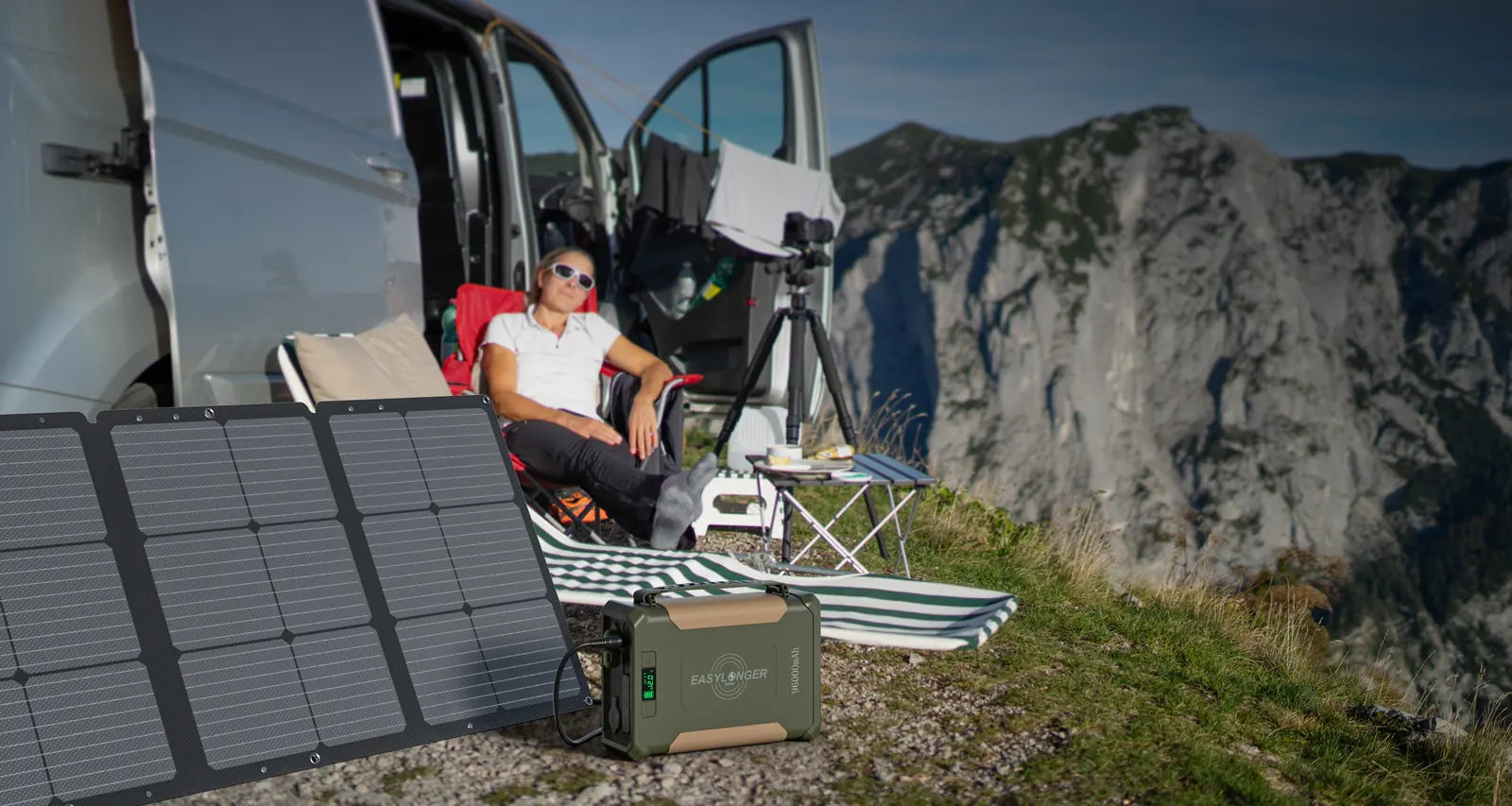 ES960 and a folding solar panel beside a camper van in the mountains