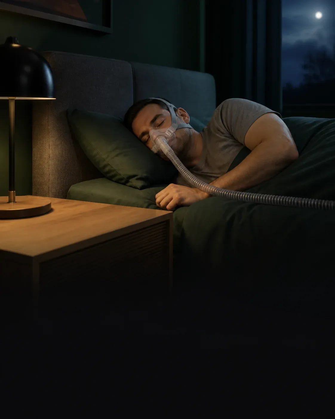 A CPAP user asleep in a dark bedroom